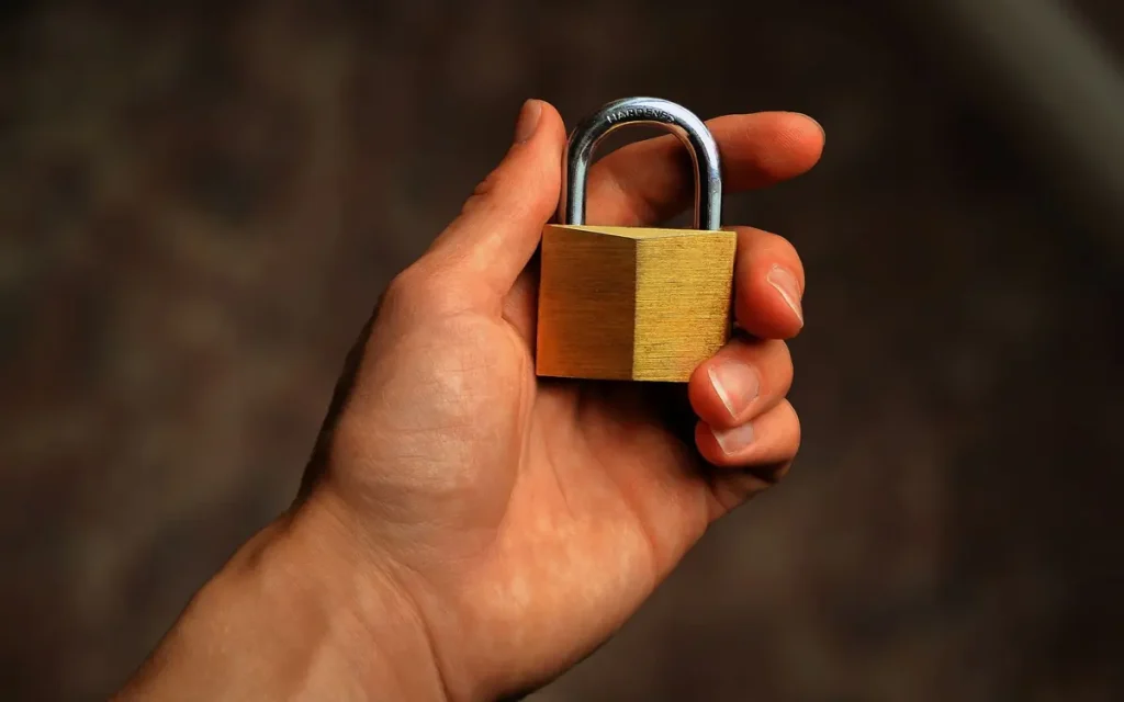 Hand holding a brass padlock, lock service in Bartow, FL