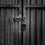 Padlock on a wooden gate, lock installation