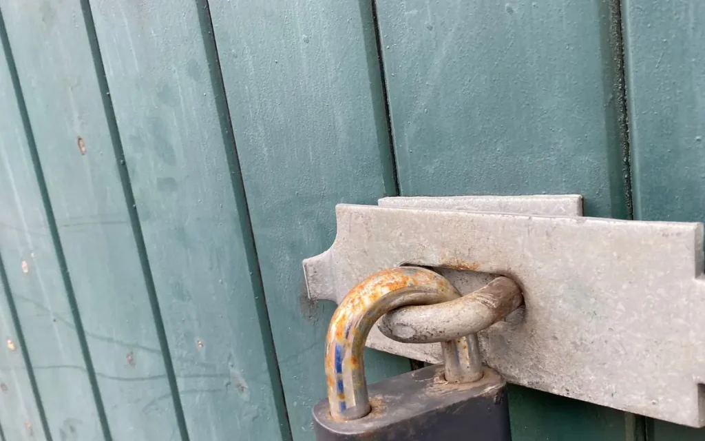 Padlock on a teal gate, lock service in Mulberry, FL
