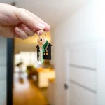 Hand holding house keys, rekey locks in Lakeland, FL