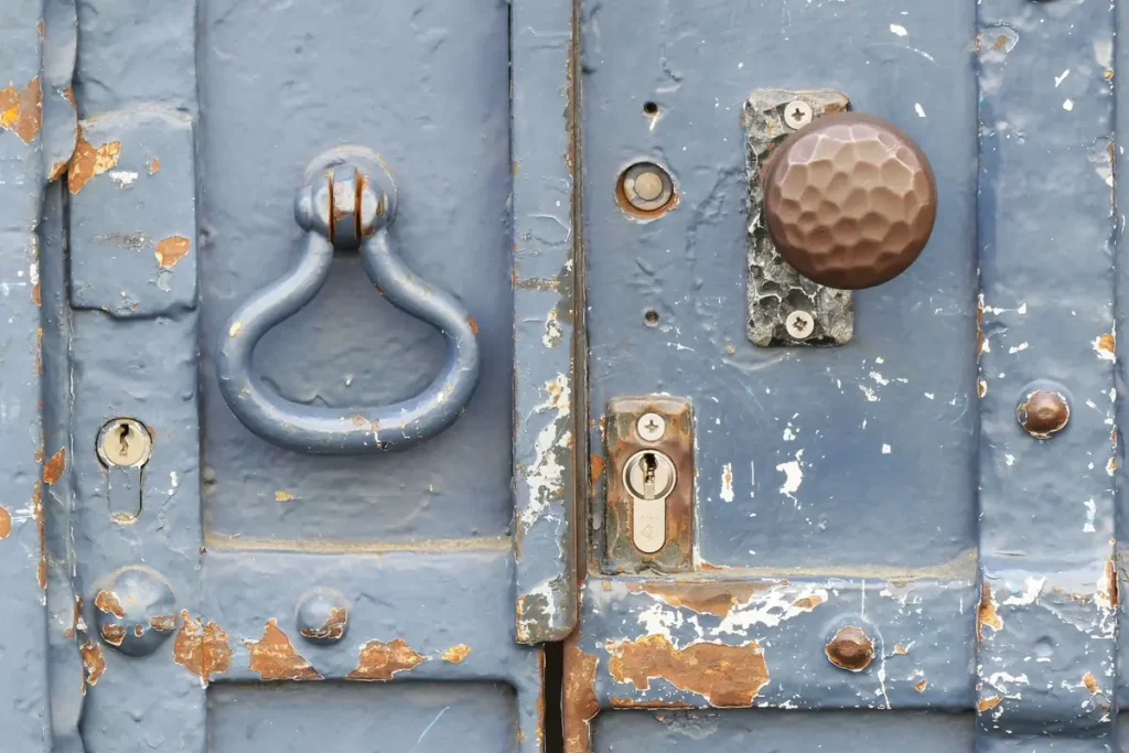 Blue painted door with old lock hardware, rekeying older doors