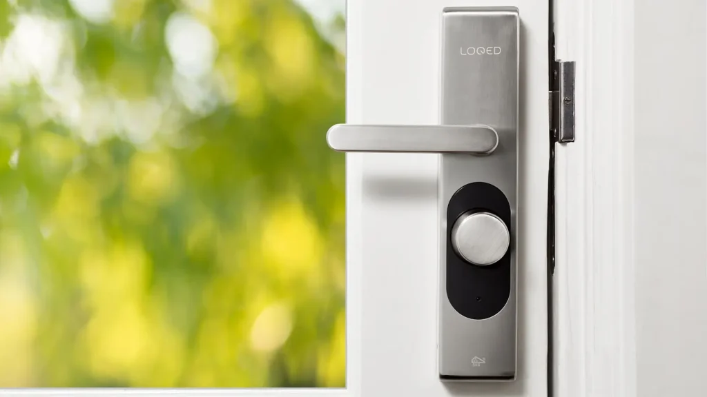 Smart door lock on a white door with a window, smart lock installation